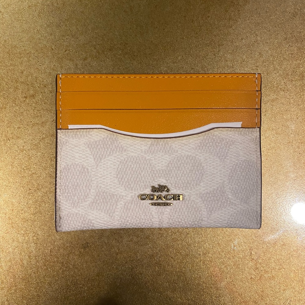 Coach wallet / cardholder. Brand new. Ivory and orange. Never used.